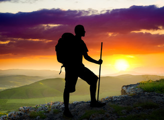 tourist on sundown background.