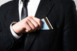 © slasnyi - businessman put or take out credit card in pocket, close up