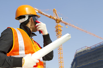 construction worker with crane in background