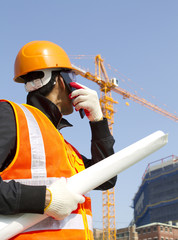 construction worker with crane in background