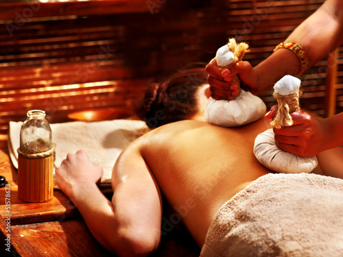 Woman having massage with pouch. - 51578673