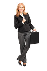 Canvas Print - Full length portrait of a mature businesswoman leaning against a