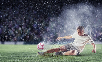 Wall Mural - football player striking the ball