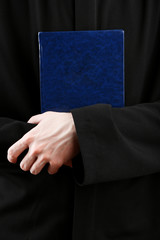 Wall Mural - Priest holding holy bible, close up