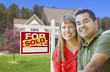© Andy Dean - Couple in Front of Sold Real Estate Sign and House
