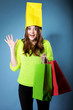 © Voyagerix - Surprised girl paper shopping bag on head. Sales.
