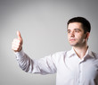 © slasnyi - business man holding his thumb up