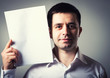 © slasnyi - businessman holding a sheet of paper