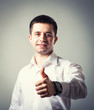 © slasnyi - man holding his thumb up