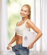 © Syda Productions - woman showing big pants and holding scales