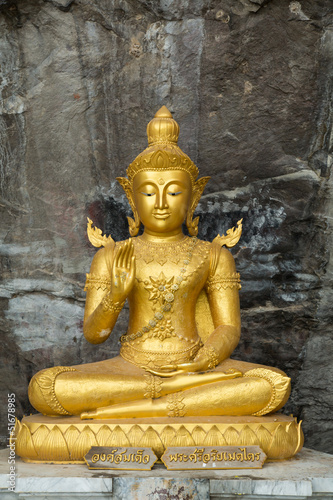 Fototapeta na wymiar Buddha on stone babkground in cave of Thailand