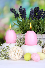  Easter candles with flowers on bright background
