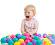 Portrait of a smiling infant playing among colorful balls