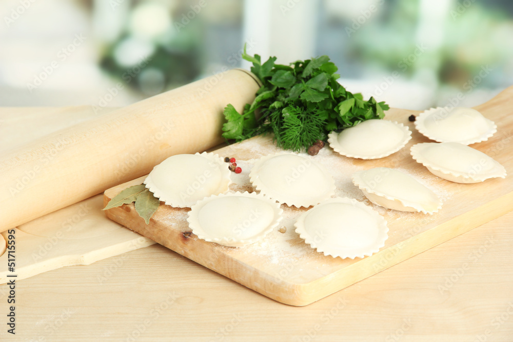 Raw dumplings and dough, on wooden table