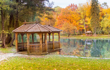 Wooden Gazebo On The Lake In The Autumn Park