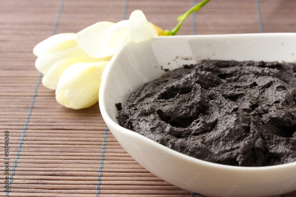 Cosmetic clay for spa treatments, on bamboo background