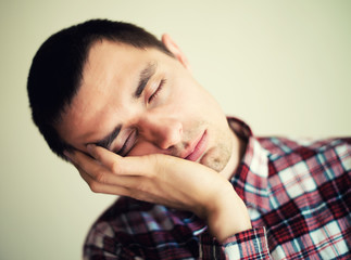 Sticker - Tired man sleeping on chair resting on his arm