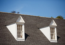 Two White Dormers On Grey Shingle Roof