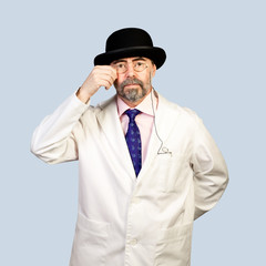 Portrait of middle-aged  retro doctor  in a hat .on a pale backg