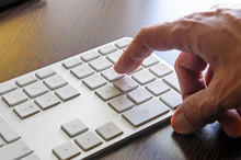 A Senior Man Is Using The Numeric Keyboard Of His Computer