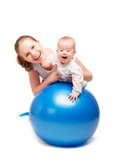 Mother And Baby Doing Gymnastic Exercises On The Ball