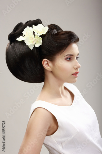 Naklejka na kafelki Charisma. Woman with Futuristic Hairstyle and Orchid Flowers