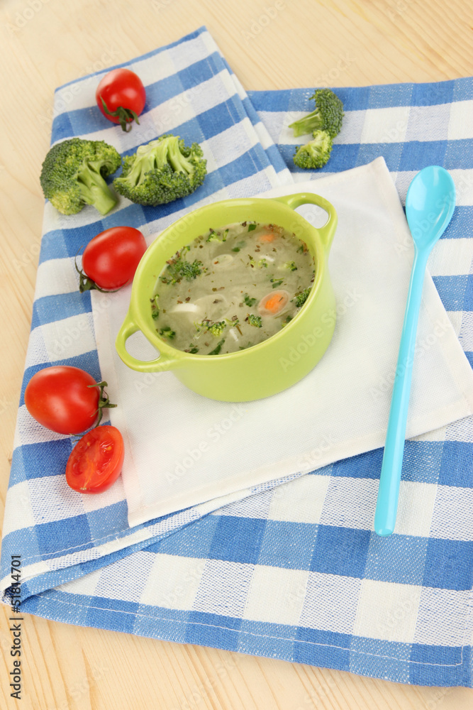 Diet soup with vegetables in pan on wooden table close-up