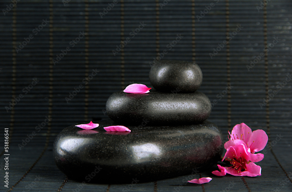 Spa stones and flowers on bamboo background