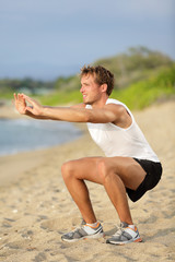 Wall Mural - Fitness man training air squat exercise on beach