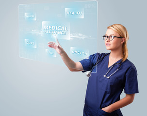 Young nurse pressing modern medical type of buttons