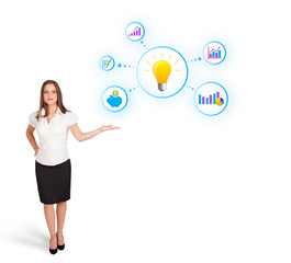 Young woman presenting light bulb with colorful graphs and diagr