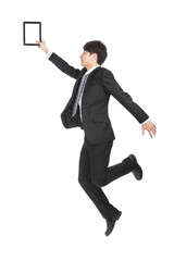 Poster - Young Businessman Holding Tablet PC Jumping