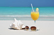 Orange juice and sunglasses on the beach. Exuma, Bahamas