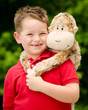 Portrait of boy playing with his stuffed animal pet