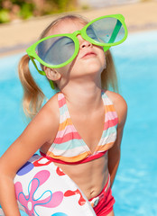 Canvas Print - little girl in the swimming pool  with rubber ring