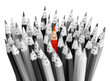 One bright color smiling pencil among bunch of gray sad pencils