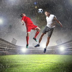 Wall Mural - two football players striking the ball