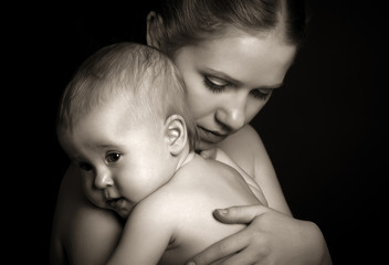 concept for love and family. mother hugging baby tenderly in mon