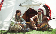 North American Indians Sit At A Wigwam