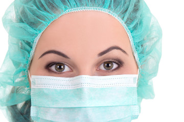 Wall Mural - close up portrait of female doctor in blue mask and cap over whi