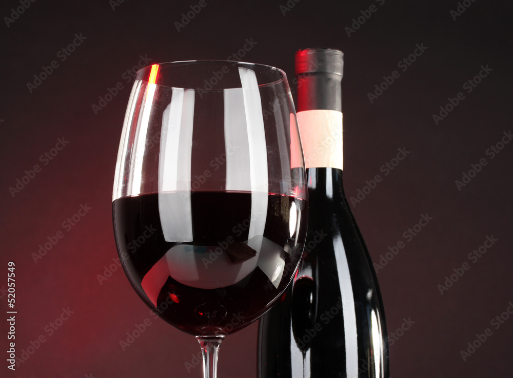Wine in glass and wine bottle close-up on dark background