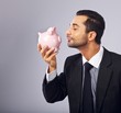 © Jacob Lund - Handsome Executive Kissing a Coin Bank