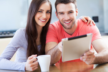 Canvas Print - Happy couple with digital tablet