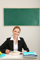 Wall Mural - Portrait of teacher woman working in classroom