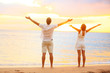 © Maridav - Happy cheering couple enjoying sunset at beach