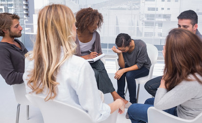 Group therapy session with one woman crying