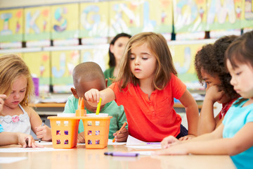 Group Of Elementary Age Children In Art Class With Teacher