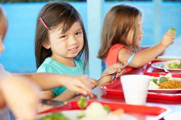 Wall Mural - Elementary Pupils Enjoying Healthy Lunch In Cafeteria