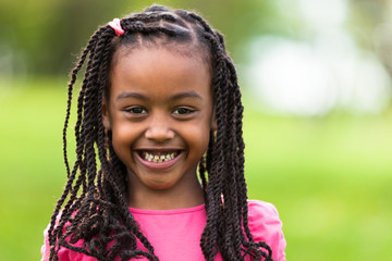 outdoor close up portrait of a cute young black girl - african p