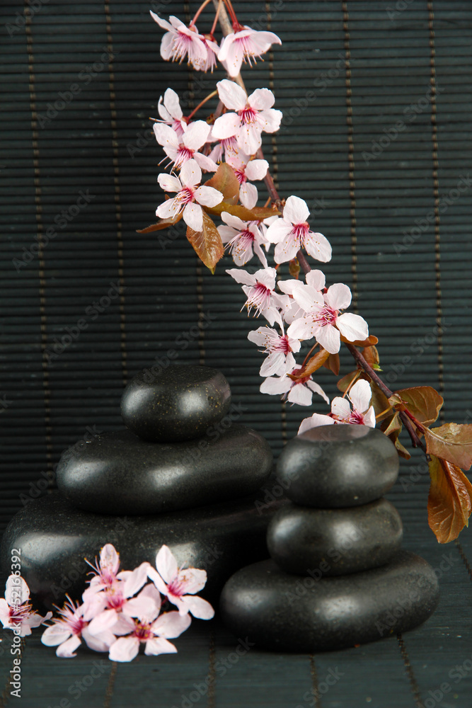 Spa stones and flowers on bamboo background